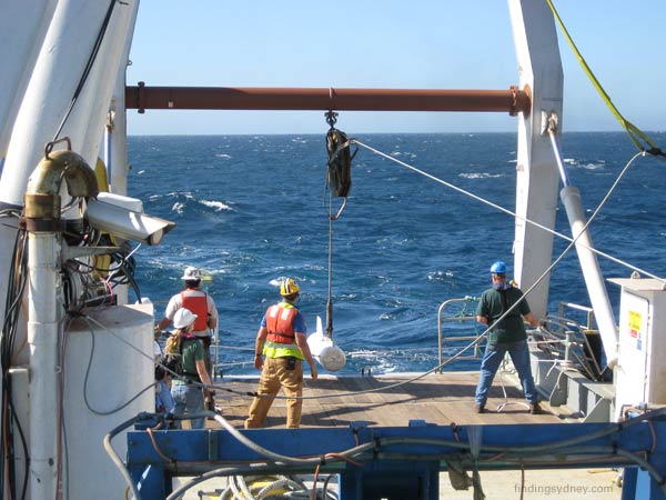 Launching the depressor weight into the sea.