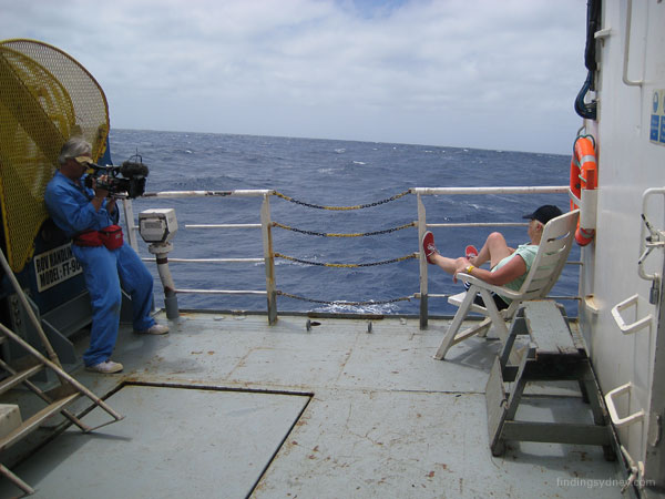 Ulle the cinematographer photographing Glenys resting on deck.