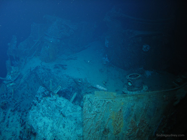 The badly damaged bridge and compass platform of HMAS Sydney, showing the base of the Director Control Tower.