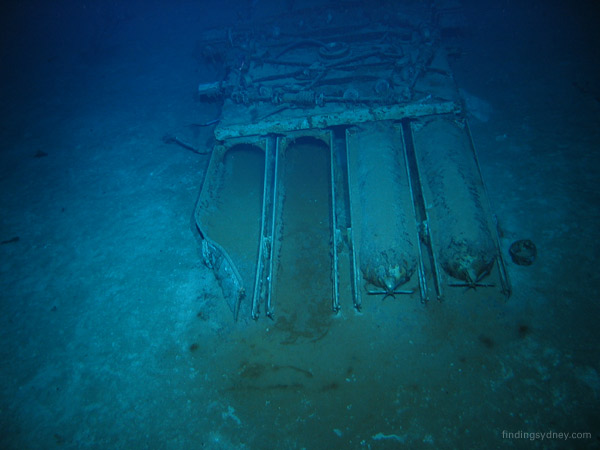 Quadruple torpedo tubes lying upside down on the sea bed.