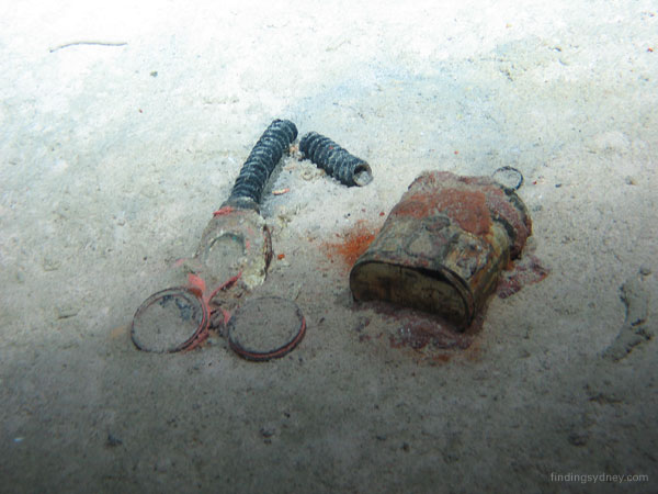 A gas mask lying on the sea bed.