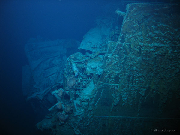 A jagged break in Kormoran’s riveted steel hull showing the violence of the internal explosion.
