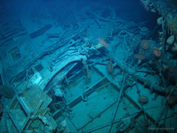 A confusing jumble of pipes, cables, and hull structure from a large piece of Kormoran wreckage.