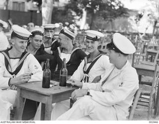 ALEXANDRIA, EGYPT. CREW MEMBERS OF HMAS SYDNEY ENJOY A DRINK IN THE BEER GARDEN AT THE ALEXANDRIA FLEET CLUB.