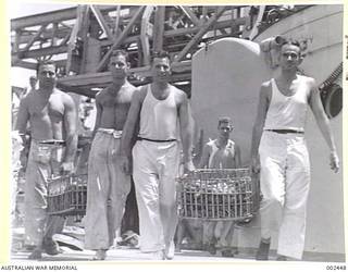 <em>SYDNEY</em> COOKS CARRY CRATES OF TOMATOES TO THE GALLEY. (NEGATIVE BY PARER).