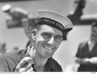 A crew member of HMAS Sydney, R20374 Able Seaman Verdum Arthur Roy Sutton, of Sydney, NSW, displays his rabbit's foot lucky charm. Able Seaman Sutton survived the war, served as a Chief Petty Officer at HMAS Commonwealth in Japan during the BCOF period, and retired in 1960. See also AWM photograph 146535.