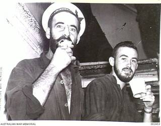 <em>SYDNEY</em> A DRINK AND AN ICE CREAM FROM SHIP'S CANTEEN. LEADING STOKER L.W. BOWEN. STOKER R.A. MILNE. (NEGATIVE BY PARER).