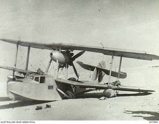 A No 9 Squadron, RAAF, Seagull V (Walrus) amphibian, which was launched from the light cruiser, HMAS Sydney II, to assist in coordinating the cruiser’s bombardment of Bardia on 21 June 1940. The aircraft was shot down by Italian fighters whilst conducting a reconnaissance of the Bardia area. Through the skill of the pilot, 172 Flight Lieutenant Thomas Macbride Price, he managed to crash land the aircraft behind friendly lines in at Mersa Matruh, Egypt, with no injuries to himself or his crew.