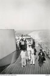 ADRIATIC SEA. 1940-06-29. A GROUP OF ITALIAN SAILORS FROM THE SUNKEN DESTROYER ESPERO ON THE QUARTER-DECK OF HMAS SYDNEY (II) JUST AFTER THE FUNERAL SERVICE FOR TWO OF THEIR SHIPMATES. (NAVAL HISTORICAL COLLECTION).