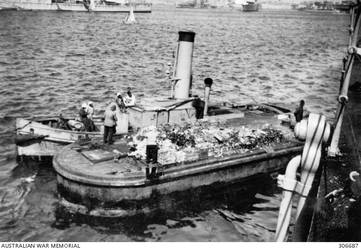 ALEXANDRIA, EGYPT. 1940-07-31. AN EGYPTIAN OFFAL LIGHTER AND A SMALL HARBOUR TUG ON THE STARBOARD SIDE OF THE CRUISER HMAS SYDNEY (II). (NAVAL HISTORICAL COLLECTION).