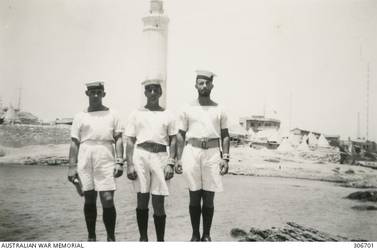 RAS EL TIN, ALEXANDRIA, EGYPT. 1940-08. MEMBERS OF THE SHIP'S COMPANY OF THE CRUISER HMAS SYDNEY (II), PETTY OFFICER FRITH AND ABLE SEAMEN HARRISON AND CLARK, ON BATHING PATROL. THE LIGHTHOUSE IS IN THE BACKGROUND. (NAVAL HISTORICAL COLLECTION).