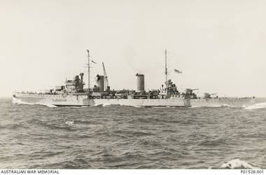 PORT SIDE VIEW OF THE CRUISER HMAS SYDNEY (II), WITH A HOLE IN THE FORWARD FUNNEL, STEAMING TOWARDS ALEXANDRIA AFTER HEAVILY DAMAGING THE ITALIAN CRUISER BARTOLOMEO COLLEONI, OFF CAPE SPADA, CRETE. (DONOR C. OLIVER, ORIGINAL ALBUM HELD IN AWM- ARCHIVE STORE)