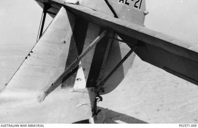 A close view of the tail section, showing the bullet holes in a No 9 Squadron, RAAF, Seagull V (Walrus) amphibian, which was launched from the light cruiser, HMAS Sydney II, after a naval bombardment of Bardia on 21 June 1940. The Australian aircraft was shot down by Italian fighters whilst conducting a reconnaissance of the Bardia area. Through the skill of the pilot he managed to crash land the aircraft behind friendly lines in Egypt with no injuries to himself or his crew.