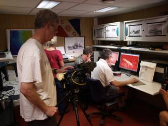 Crew looking at computers showing sonar of the Sydney wreck