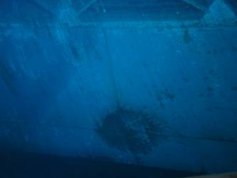 Shell hit on port side below X support near drying room