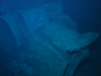 A gun turret with foredeck folded back over gun barrels