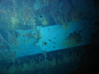 Shell hits beneath superstructure on ship's port side