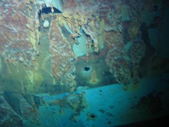 Shell hits beneath superstructure on ship's port side