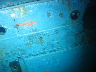 Shell hits beneath superstructure on ship's port side