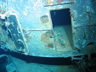 Rear of X turret showing damage and hatch doors open