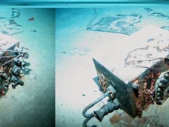 Rectangular box with piping and inspection cover on seabed