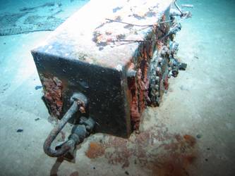 Rectangular box with piping and inspection cover on seabed