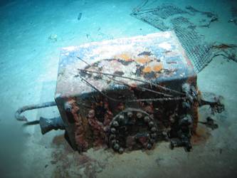 Rectangular box with piping and inspection cover on seabed