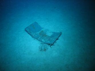 Flat metal rectangular wreckage on seabed