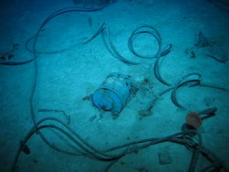 Steel wire rope on seabed near cylindrical drum