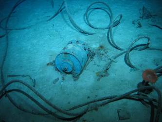 Steel wire rope on seabed near cylindrical drum