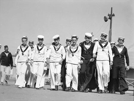 A dozen of sailors from HMAS Sydney (II) in uniform walking as a group